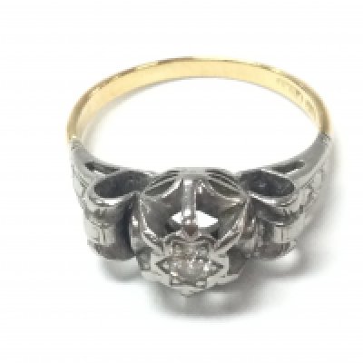 An 18ct gold and platinum ring set with small chip stone diamond. Size O and 4.06g. Postage B