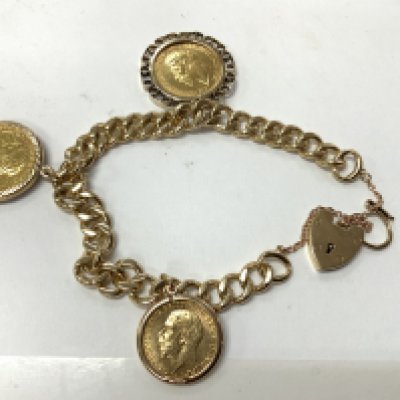 A 9ct gold bracelet with 2 Sovereign and Half Sovereign coins in mounts 1929 full, 1894 full, 1914 1/2. Total weight 50.55g. Postage category A.