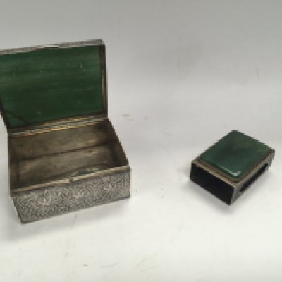 A white metal box and matchbox holder with quartz inserts.