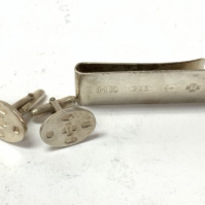 Millennium cuff links and money clip. Postage category A.