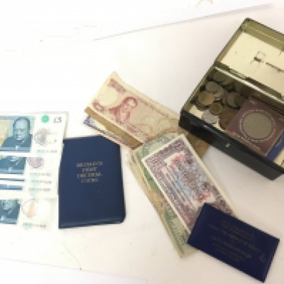 A collection of unused five pound notes other bank notes and some coins.