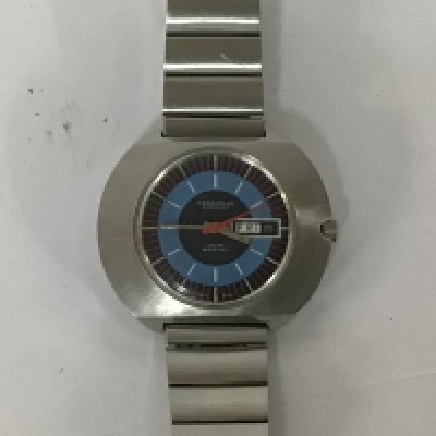 A Gents Caravelle Division of Buolva watch Automatic wind with a shaped steel wide edge modern design case the dial with a blue band red markers and day date aperture seen working with box few minor scratches.