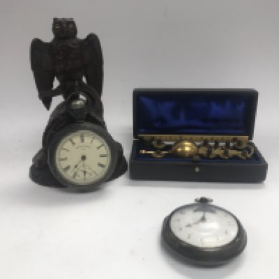 Two vintage pocket watches and an owl carved watch stand with a Sykes hydrometer.
