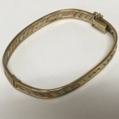 A 9carat gold tri-colour bangle. Weight 10.5g.
