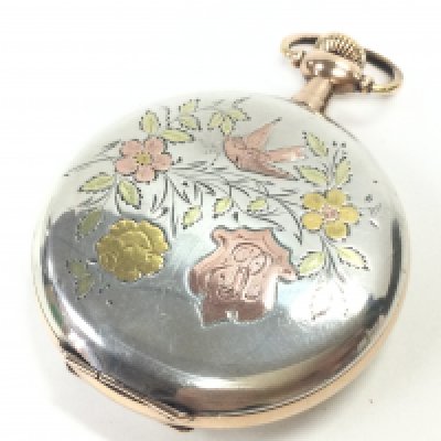 A silver and gold pocket watch. Postage category A