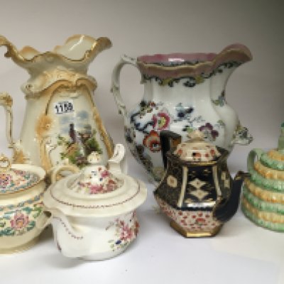 Two large Victorian jugs and four decorative tea pots.