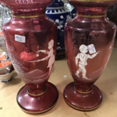 A pair of Victorian style cranberry vases .