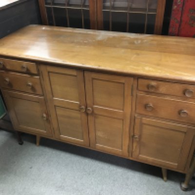 A mid 20th century design Ercol sideboard fitted with drawers and cupboards. Dimensions 50x130x86cm.