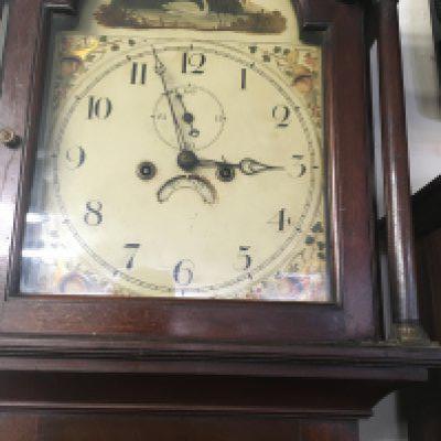 A mahogany Long case clock the paint arched dial with Arabic numerals.