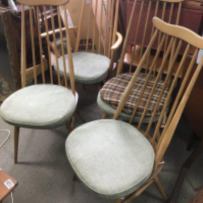 A set of four Mid 20th century Ercol blonde and light wood dining table chairs. Dimensions 95x42cm