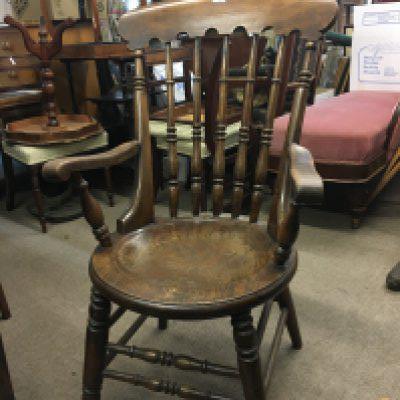 An Antique Elm and beechwood chair with turned supports and a solid shaped seat.