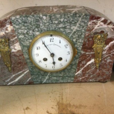 Three mantle clocks two of Art Deco style the other in the form of a castle.