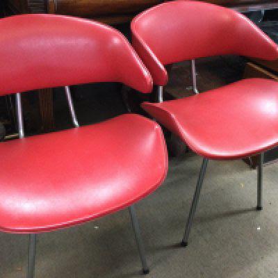 A set of four modern design chairs with tapering chrome legs .
