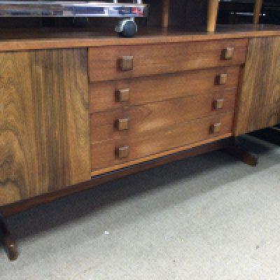 A Morden design sideboard the rectangular top above four drawers flanked by cupboards on shaped legs United by a under stretcher. With applied label Vanson . 6.2 ft 1.5 ft