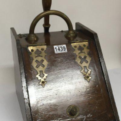 An Edwardian walnut coal box with ornate brass hinges a loop handle and a shovel.