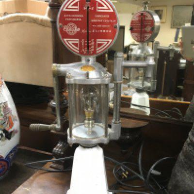A converted oil pump for use as a table lamp, approx height 67.5cm. Shipping category D.