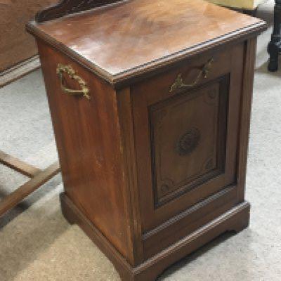An Edwardian walnut coal box with a hinged front and side brass handles.
