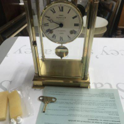 A Sewills brass pendulum mantle clock. Winds and runs. 17cm wide and 28cm high. Postage D