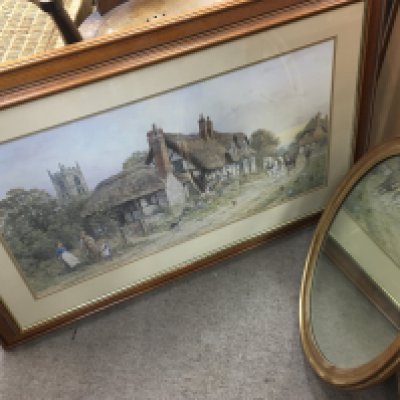 A large print of a J.L Chapman watercolour rural scene and an oval gilt mirror