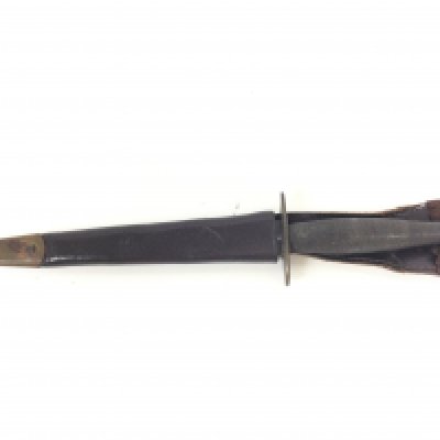 A Fairbairn Sykes fighting knife with scabbard. 29cm long. This lot cannot be posted