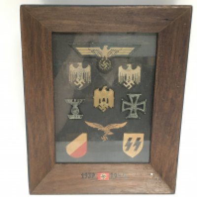 A small glazed framed collection of Nazi badges. This lot cannot be posted