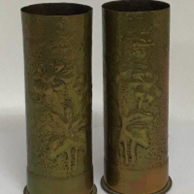 A pair of I world war trench art brass shell cases with hammered decoration raised flowers. Hight 23cm