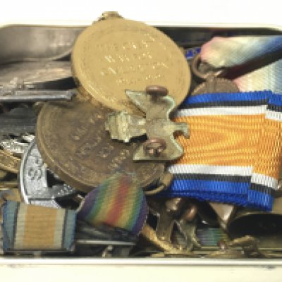 A collection of medals including a 1914-15 star and the Victory medal presented to SS.116343 J.T Welsh STO.1.R.N, 1914-15 star and a war medal presented to 146524 P.J Spinner C.P.O.,R.N. Also a collection of various cap badges and other items. Postage category a
