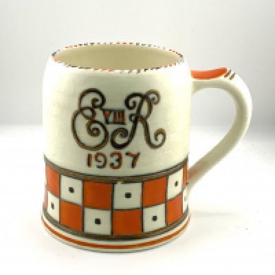 A Crown Ducal Royal Commemorative Edward VIII Coronation tankard, by Charlotte Rhead, of circular form decorated with ER monogram with a geometric chequer border banding in orange and cream, on a circular foot, printed marks beneath, unsigned, 12cm. (D)
