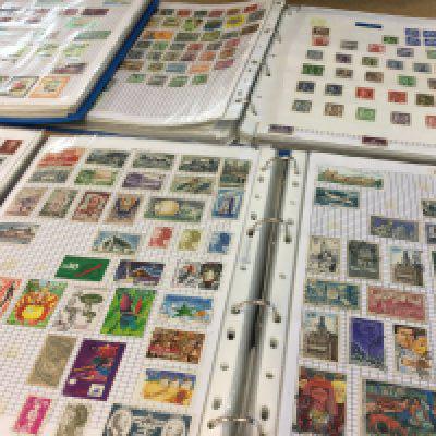 A collection of world stamps in blue albums.