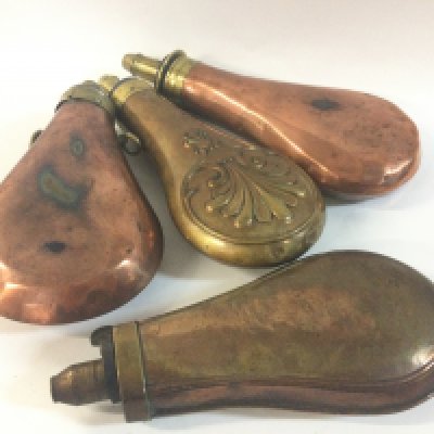 Four 19th century brass and copper gun powder flasks. NO RESERVE