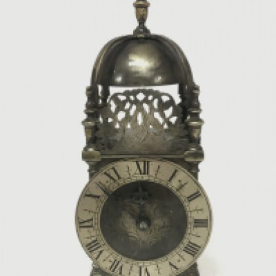 A vintage brass lantern clock with a windup French movement. 31cm tall. Seen working. Postage category C