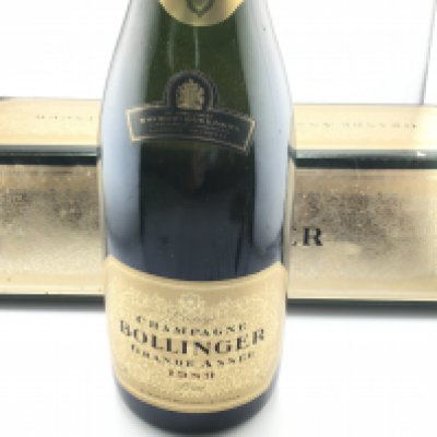 A bottle of vintage bollinger champagne with box. Postage D