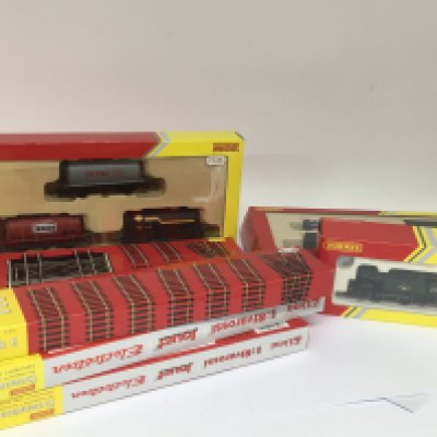 A OO gauge train set boxed Hornby wagons track a boxed locomotive and a bag containing a layout and other track and accessories.