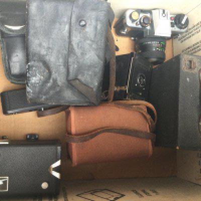 A collection of various cameras. Including cased praktica with lenses.