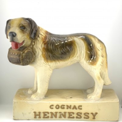 A vintage composite Cognac Hennessy St Bernard advertising figure, 26cm. Together with a resin figure of a camel. (D)
