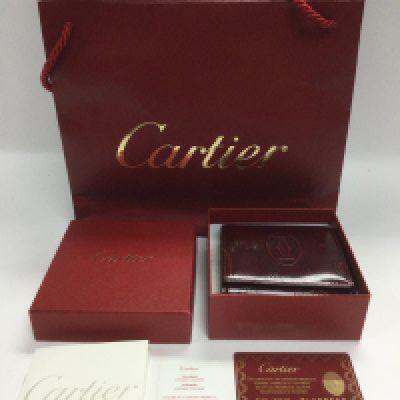 A boxed Cartier leather purse, as new, with outer bag, card and booklet. Shipping category B.