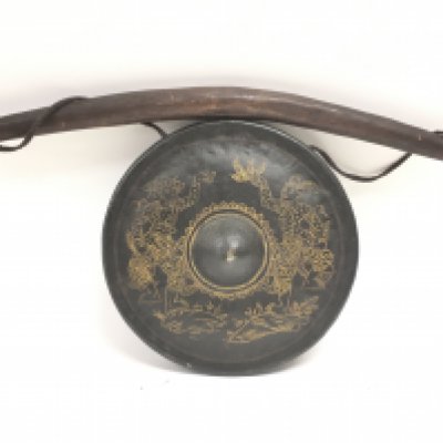 A gong on a wooden handle, possibly Tibetan. Gong 22cm wide. Postage category c