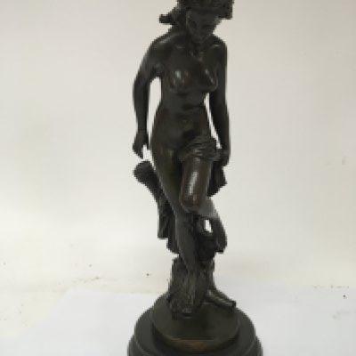A 20th century bronze figure of a Neo -Classical inspired nude female on a marble base.