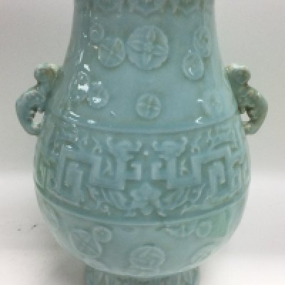 A Celadon vase decorated with various raised symbols and having faux handles to either side, approx height 35cm. Shipping category D.