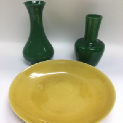 An oriental dish with character marks to base, approx diameter 27cm, together with two green vases, tallest approx 21.5cm (3). Shipping category D.