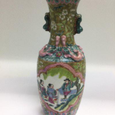 An Oriental vase decorated with panels of figures in a landscape setting, approx height 25.5cm. Shipping category D.