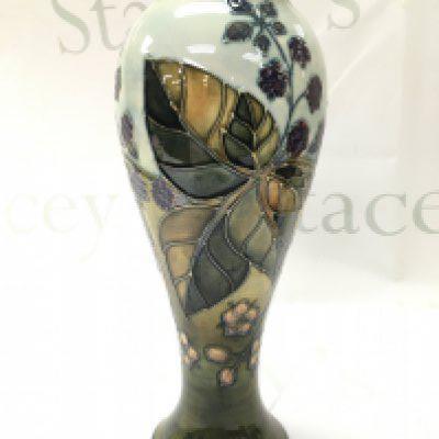 A Moorcroft bramble pattern vase, signed WM at base. 27.5cm tall. No obvious damage or restoration This lot cannot be posted