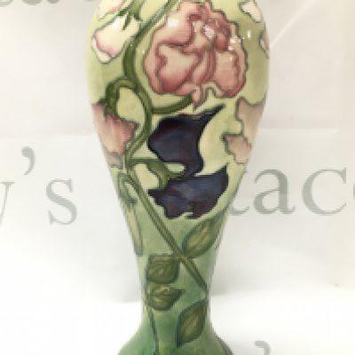 A Moorcroft Sweet Pea vase signed WM at base , 26.5cm tall. No obvious damage or restoration. This lot cannot be posted