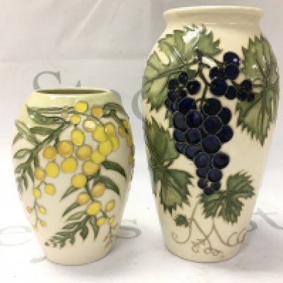 Moorcroft vases including a Grapevine vase and Golden Wattle vase, 13 and 19cm tall. No obvious damage or restoration This lot cannot be posted
