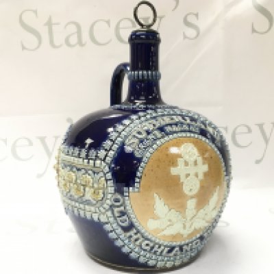 A Doulton Lambeth Stoneware Whisky Flask, circa 1898, applied thistle design and SUTHERLAND GRANT, MACKAY & Co OLD HIGHLAND WHISKY, with impressed factory marks at the base. This lot cannot be posted