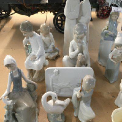A collection of LLadro figures including young children. (8) .