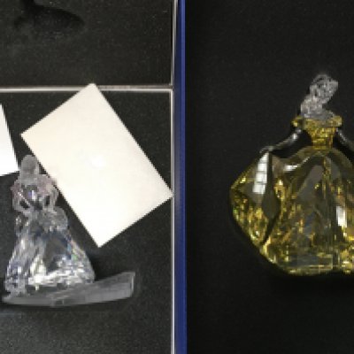 Two boxed Swarovski Disney figures- Cinderella and Belle, together with a certificate of authenticity. No obvious damage or restoration