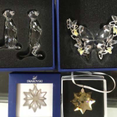 Four boxed Swarovski items including butterfly group, pair of Meerkats and two snowflake pendants. No obvious damage or restoration