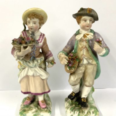A pair of Sitzendorf porcelain figures of a boy and girl flower seller. 14.5cm