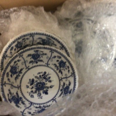 Three boxes containing a blue and white dinner and tea set and other ceramics.